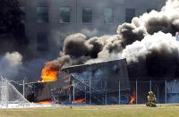 Firefighters work to put out the flames moments after a hijacked jetliner crashed into the Pentagon, Sept. 11, 2001